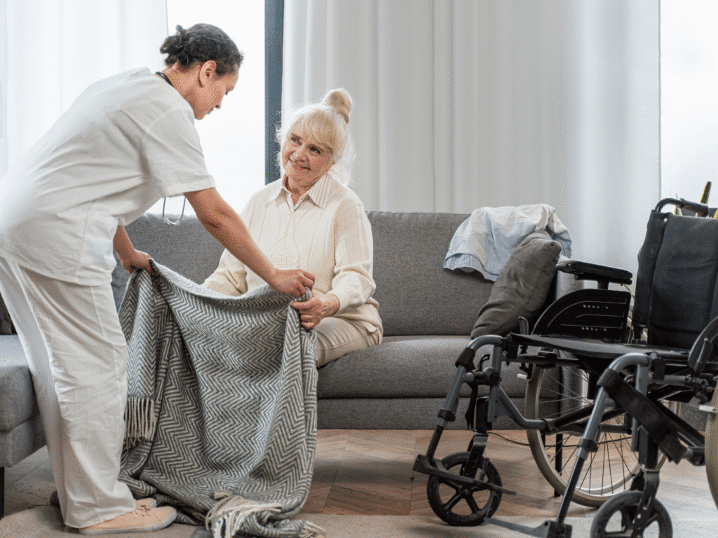 An elderly woman in a couch with her support worker